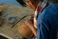 Selective focus on hands of old man makes traditional basket by weaving the natural material Royalty Free Stock Photo