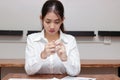 Selective focus on hands of stressed tired young Asian business woman feeling depressed worried about problem in workplace of