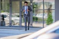 Focus of handsome african american businessman walking on stairs