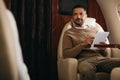 selective focus of handsome bearded man using digital tablet in private jet. Royalty Free Stock Photo