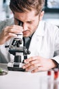 selective focus of handsome biochemist looking Royalty Free Stock Photo