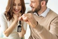 Focus of handsome man holding car key and looking at happy brunette woman Royalty Free Stock Photo