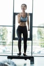Focus of happy girl working out on step platform in sports center Royalty Free Stock Photo