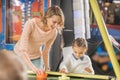 selective focus of happy mother and daughter playing air hockey in entertainment Royalty Free Stock Photo