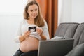 Selective focus of happy pregnant woman showing ultrasound photos while having video call Royalty Free Stock Photo