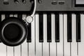 Selective focus headphone on key piano background. Royalty Free Stock Photo