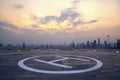 Selective focus of the Heli Copter parking lot on the deck at sunset in the capital of Thailand. Space for helicopter landing on