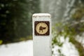 Selective focus on the historical Santiam Wagon Road marker under the snow