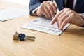 Focus of house dealer holding pen near contract and car key