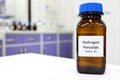 Selective focus of hydrogen peroxide solution in brown amber bottle. Blur laboratory background with copy space.