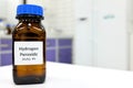 Selective focus of hydrogen peroxide solution in brown amber bottle. Blur laboratory background with copy space. Royalty Free Stock Photo