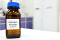 Selective focus of hydrogen peroxide solution in brown amber bottle. Blur laboratory background with copy space.