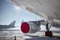 Grounded plane at snowy airport in frosty day