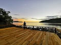 Beautiful seascape view with a man silhoutte and wooden veranda during sunset at Bahku Island,Kota Belud,Sabah,Borneo.