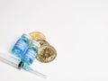 Selective focus image Corona virus vaccines with syringe and bitcoin isolated on white background.
