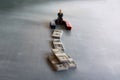 Selective focus image of miniature businessman attracts money using magnet