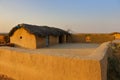 Mud house with thatched roof in an village in Rajasthan India Royalty Free Stock Photo