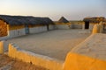 Mud house with thatched roof in an village in Rajasthan India Royalty Free Stock Photo