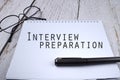 Selective focus image of pen and spectacles with Interview Preparation wording on a wooden background Royalty Free Stock Photo