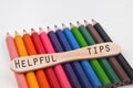 Selective focus image of pencil color with HELPFUL TIPS wording isolated on a white and blur background. Education concept Royalty Free Stock Photo