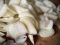 Sliced garlic on wooden cutting board Royalty Free Stock Photo