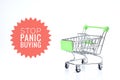 Selective focus image of trolley cart with Stop Panic Buying wording isolated in white background. Economy and buy sell concept Royalty Free Stock Photo