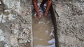 Selective focus image, workers clearing sewers from clogged trash