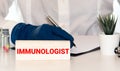 selective focus of immunologist holding pen near clipboard with checklist