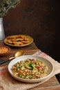 Selective focus of Indonesian cuisine named oblok obok in a plate on the wooden table in dark background