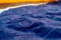 Selective focus of an inflatable air mattress on the floor of a tent being filled up.