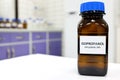 Selective focus of isopropanol brown amber glass bottle inside a laboratory. Blurred background with copy space. Royalty Free Stock Photo