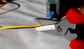 Selective focus scissors cut fiber optic network cables. cut the internet network cable. Royalty Free Stock Photo