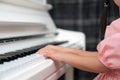 Selective focus on the kid finger playing grand piano. Teacher or instructor teach a girl on the class play melody. Close up hand Royalty Free Stock Photo