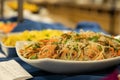 Selective focus of Korean funchose noddles on a white platter