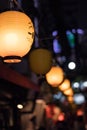Selective Focus. Lantern hangging overhead in Omoide Yokocho in Shinjuku. Portrait Orientation