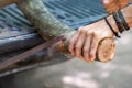 selective focus large branches Men are using Bow Saw to cut wood to make firewood to collect for winter use