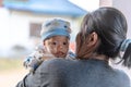 Selective focus on left eye of adorable newborn baby child boy resting in mother`s arms at home