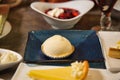 Selective focus on a lemon ice cream on a plate at a table with varied desserts at a buffet