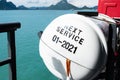 Selective focus at life raft safety equipment on Sea ship transport with Ocean and island at the background.  Standard protection Royalty Free Stock Photo