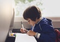 Selective focus of little boy draws with coloured pen on white paper, Kid traveling by the train, Little boy in a high speed expre Royalty Free Stock Photo