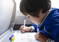 Selective focus of little boy draws with coloured pen on white paper, Kid traveling by the train, Little boy in a high speed expre Royalty Free Stock Photo