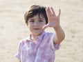 Selective focus of little boy showing five fingers, Portrait kid primary school counting number five, Child showing five numbers