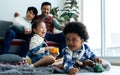 Selective focus little sweet happy diverse Caucasian and African girl and boy playing toys together, smiling in living room at Royalty Free Stock Photo