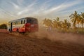 Selective focus Local Bus driving fast with dust cloud on road to Bidar