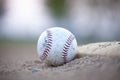 Selective focus low angle view of an old baseball next to a base Royalty Free Stock Photo