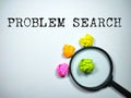 Selective focus.Magnifying glass with colorful crumpled paper with word problem search on white background. Business concept. Royalty Free Stock Photo