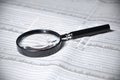 selective focus of magnifying glass and list of stock on newspaper Royalty Free Stock Photo