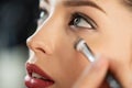 Focus of makeup artist applying concealer on woman Royalty Free Stock Photo