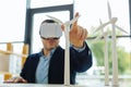 Selective focus of a male finger touching a windmill model