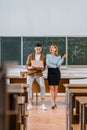 Selective focus of male student and female teacher using laptop during lesson Royalty Free Stock Photo